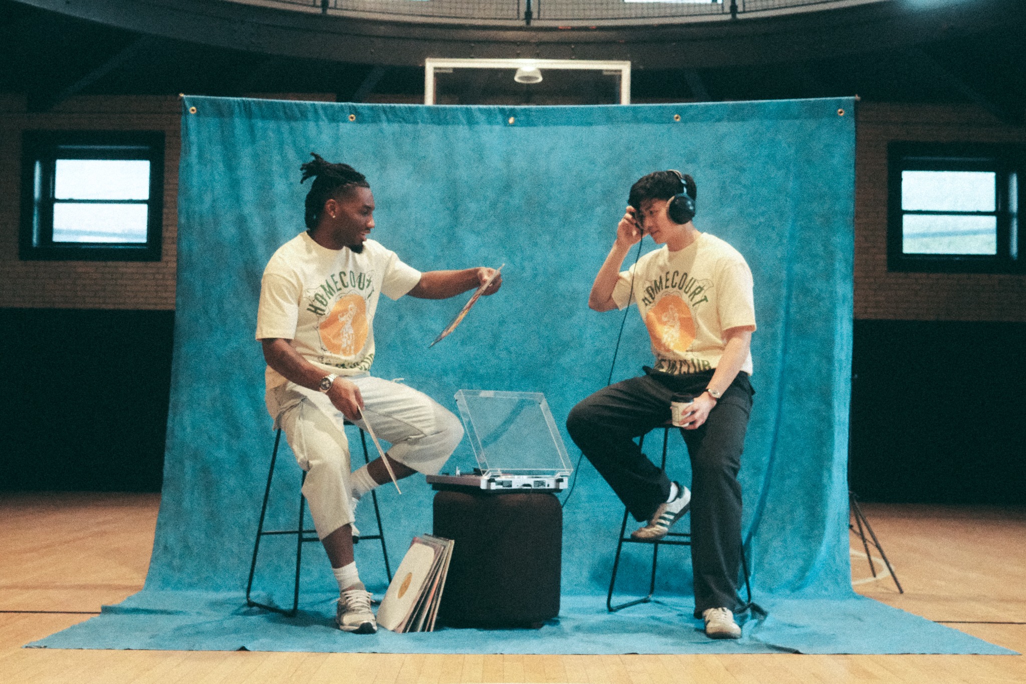 Two W Club members listening to a record on the court