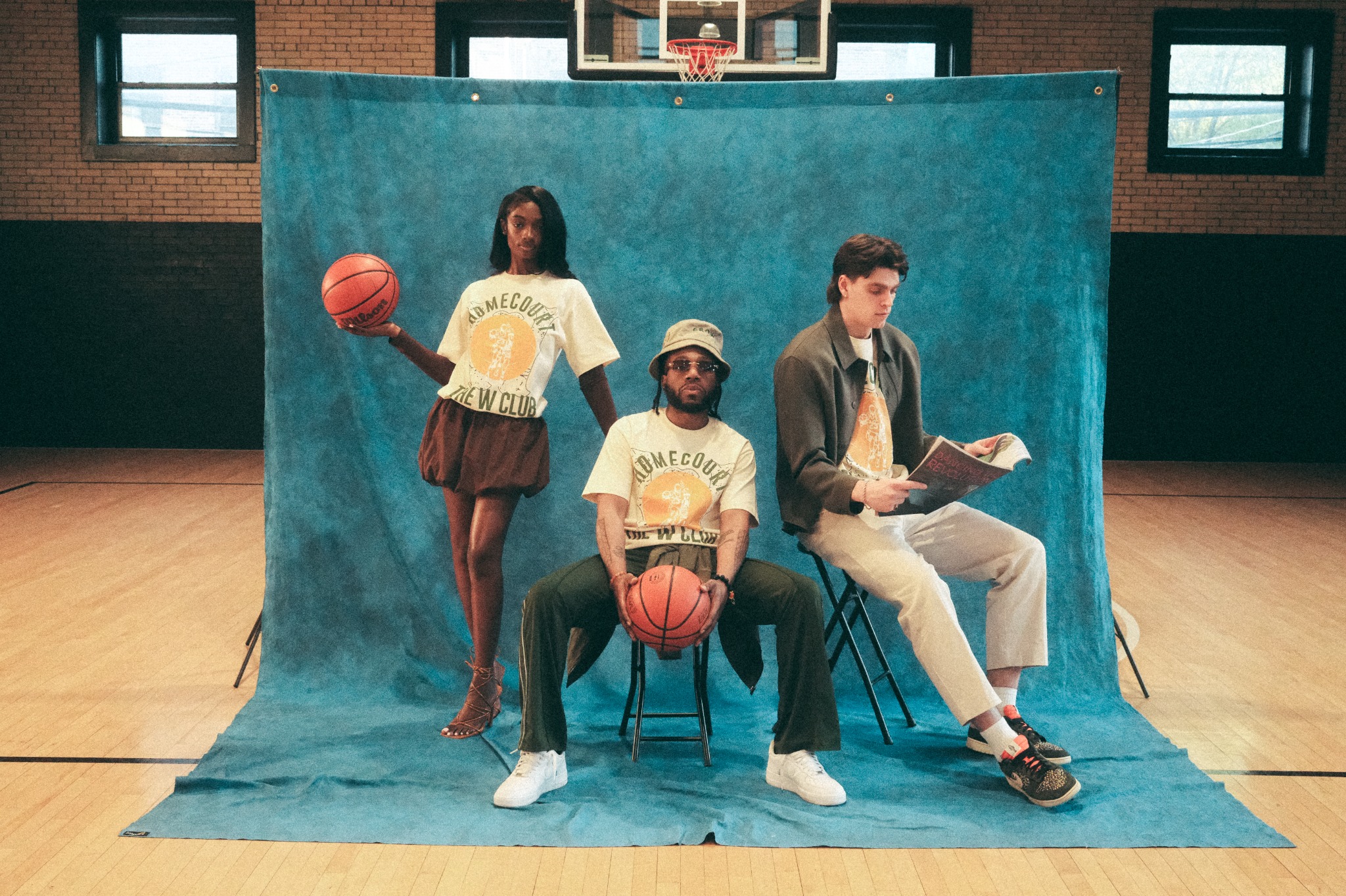 W Club members posed on a basketball court