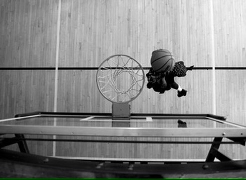 A basketball falling through the rim from above