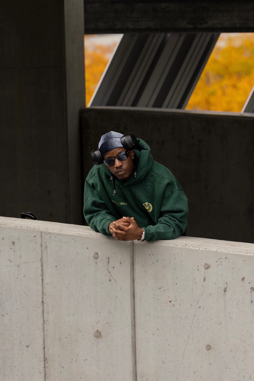 W Club forest-green Travel Suit portrait in a concrete parking structure